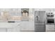 Stainless steel appliances and white shaker cabinets in updated kitchen at 5790 Midnight Pass Rd # 602, Sarasota, FL 34242