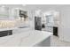 Modern kitchen with island, stainless steel appliances, and white cabinets at 5790 Midnight Pass Rd # 602, Sarasota, FL 34242
