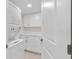 Stackable washer and dryer with white cabinets at 5790 Midnight Pass Rd # 602, Sarasota, FL 34242