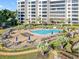 Resort-style pool with ample lounge chairs and patio tables at 5790 Midnight Pass Rd # 602, Sarasota, FL 34242