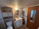 Bathroom with toilet, sink, and built-in storage at 611 50Th Avenue W Dr, Bradenton, FL 34207