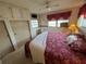 Main bedroom with king bed, built-in shelving, and ample closet space at 611 50Th Avenue W Dr, Bradenton, FL 34207
