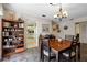 Charming dining room with wood table and built-in shelving at 704 Harrington Lake S Dr # 6, Venice, FL 34293