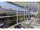 Relaxing screened patio with lush landscaping and seating at 704 Harrington Lake S Dr # 6, Venice, FL 34293