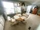 Light-filled dining area, featuring an octagonal table and four chairs at 727 Blackburn Blvd, North Port, FL 34287