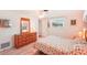 Bedroom with wood furniture and floral bedding at 872 Mohawk Rd, Venice, FL 34293