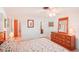 Bedroom with wood dresser and floral bedding at 872 Mohawk Rd, Venice, FL 34293