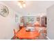Dining area with an octagonal wood table and view into living room at 872 Mohawk Rd, Venice, FL 34293