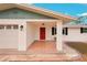 Covered front porch with tile flooring and red front door at 872 Mohawk Rd, Venice, FL 34293