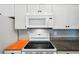 White kitchen cabinets, granite countertops, and modern appliances at 872 Mohawk Rd, Venice, FL 34293