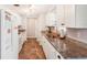 Kitchen with white cabinets, granite countertops and stainless steel appliances at 872 Mohawk Rd, Venice, FL 34293