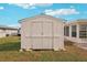 White storage shed in backyard at 872 Mohawk Rd, Venice, FL 34293