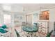 Bright sunroom with glass doors and wicker furniture at 872 Mohawk Rd, Venice, FL 34293