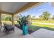 Peaceful backyard view from covered porch, showcasing lush greenery at 9325 Crugar Ter, Englewood, FL 34224