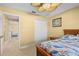 Bedroom with a double bed, ceiling fan and access to another bedroom at 9325 Crugar Ter, Englewood, FL 34224