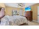 Bedroom with a wooden dresser and a view of the pool from sliding glass doors at 9325 Crugar Ter, Englewood, FL 34224