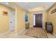 Bright and airy entryway with tile flooring and unique wall art at 9325 Crugar Ter, Englewood, FL 34224