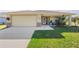 Well-maintained single-story home with a spacious driveway and landscaped lawn at 9325 Crugar Ter, Englewood, FL 34224