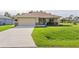 Single-story home with attached garage and well-manicured lawn at 9325 Crugar Ter, Englewood, FL 34224