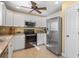 Modern kitchen featuring stainless steel appliances and white cabinetry at 9325 Crugar Ter, Englewood, FL 34224