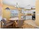 Eat-in kitchen with white cabinets and granite countertops at 9325 Crugar Ter, Englewood, FL 34224