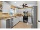 Bright kitchen with granite countertops, stainless steel appliances, and white cabinets at 9325 Crugar Ter, Englewood, FL 34224