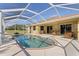 Inviting kidney-shaped pool with screened enclosure at 9325 Crugar Ter, Englewood, FL 34224