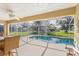 Relaxing screened pool area with patio furniture at 9325 Crugar Ter, Englewood, FL 34224