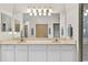 Double vanity bathroom with a large mirror and shower at 9607 Sea Turtle Ter # 101, Bradenton, FL 34212