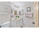 Clean bathroom with white vanity, mirror, and updated light fixtures at 9607 Sea Turtle Ter # 101, Bradenton, FL 34212