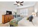 Bright bedroom with a king-size bed, dresser, and sliding door to balcony at 9607 Sea Turtle Ter # 101, Bradenton, FL 34212