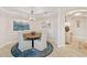 Elegant dining room with a round wooden table and stylish chandelier at 9607 Sea Turtle Ter # 101, Bradenton, FL 34212