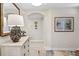 Light and airy entryway with decorative art and a large mirror at 9607 Sea Turtle Ter # 101, Bradenton, FL 34212