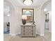 Elegant entryway with a decorative dresser and a large mirror at 9607 Sea Turtle Ter # 101, Bradenton, FL 34212