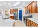 Modern kitchen with stainless steel appliances and light wood cabinets at 9607 Sea Turtle Ter # 101, Bradenton, FL 34212