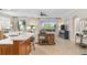 Open concept kitchen with island, white countertops, and wooden cabinets at 9607 Sea Turtle Ter # 101, Bradenton, FL 34212