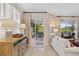 Living room with access to patio, featuring water views and stylish decor at 9607 Sea Turtle Ter # 101, Bradenton, FL 34212