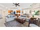 Spacious living area showcasing comfortable sofas, a coffee table and kitchen access at 9607 Sea Turtle Ter # 101, Bradenton, FL 34212