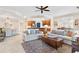 Bright and airy living room with ample seating and a view of the kitchen and dining area at 9607 Sea Turtle Ter # 101, Bradenton, FL 34212