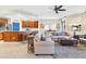 Open living room featuring comfortable sofas, a coffee table, and a view into the kitchen at 9607 Sea Turtle Ter # 101, Bradenton, FL 34212