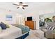 Spacious main bedroom with a king-size bed and access to a private balcony at 9607 Sea Turtle Ter # 101, Bradenton, FL 34212