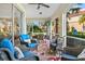 Relaxing screened porch with wicker furniture and a view of lush landscaping at 9607 Sea Turtle Ter # 101, Bradenton, FL 34212