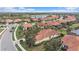 Aerial view of a community with houses and a lake at 101 Bolanza Ct, North Venice, FL 34275