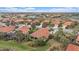 Aerial view of a community with houses and a lake at 101 Bolanza Ct, North Venice, FL 34275