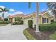 Exterior of charming house with tile roof and landscaping at 101 Bolanza Ct, North Venice, FL 34275