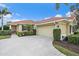 Exterior of house with tile roof and attached garage at 101 Bolanza Ct, North Venice, FL 34275