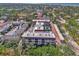 Aerial view showing condo building, pool, and lush landscaping at 101 Park N Blvd # 111, Venice, FL 34285