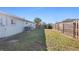 Fenced backyard with grassy area and gate at 1040 Hope St, Venice, FL 34285