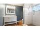 Updated bathroom with white vanity, frameless shower, and mosaic tile floor at 1040 Hope St, Venice, FL 34285