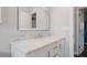 Bathroom vanity with white cabinets and marble countertop at 1040 Hope St, Venice, FL 34285